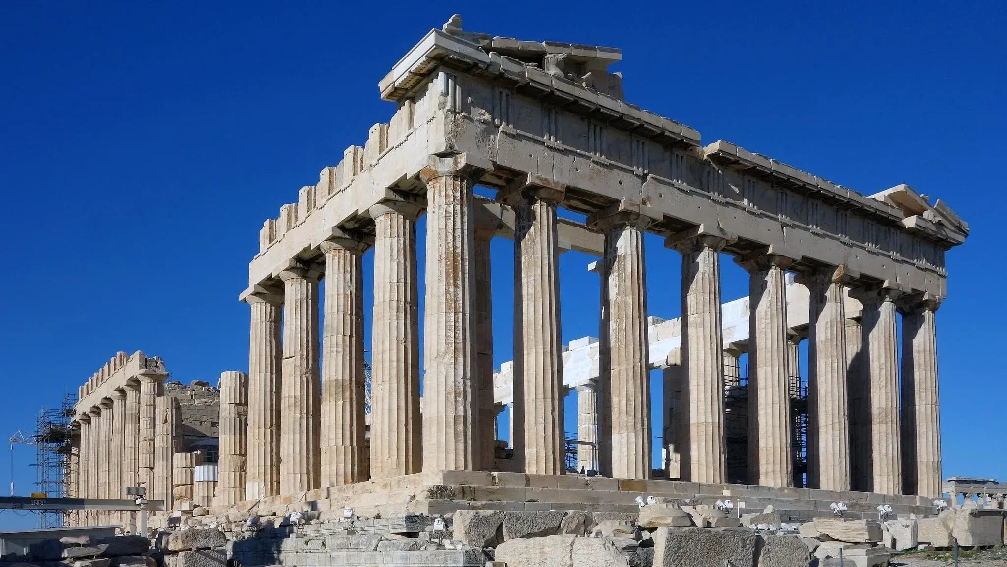 Aged and Weathered Stone, Ancient Greek Parthenon temple featuring weathered marble Doric columns under blue sky
