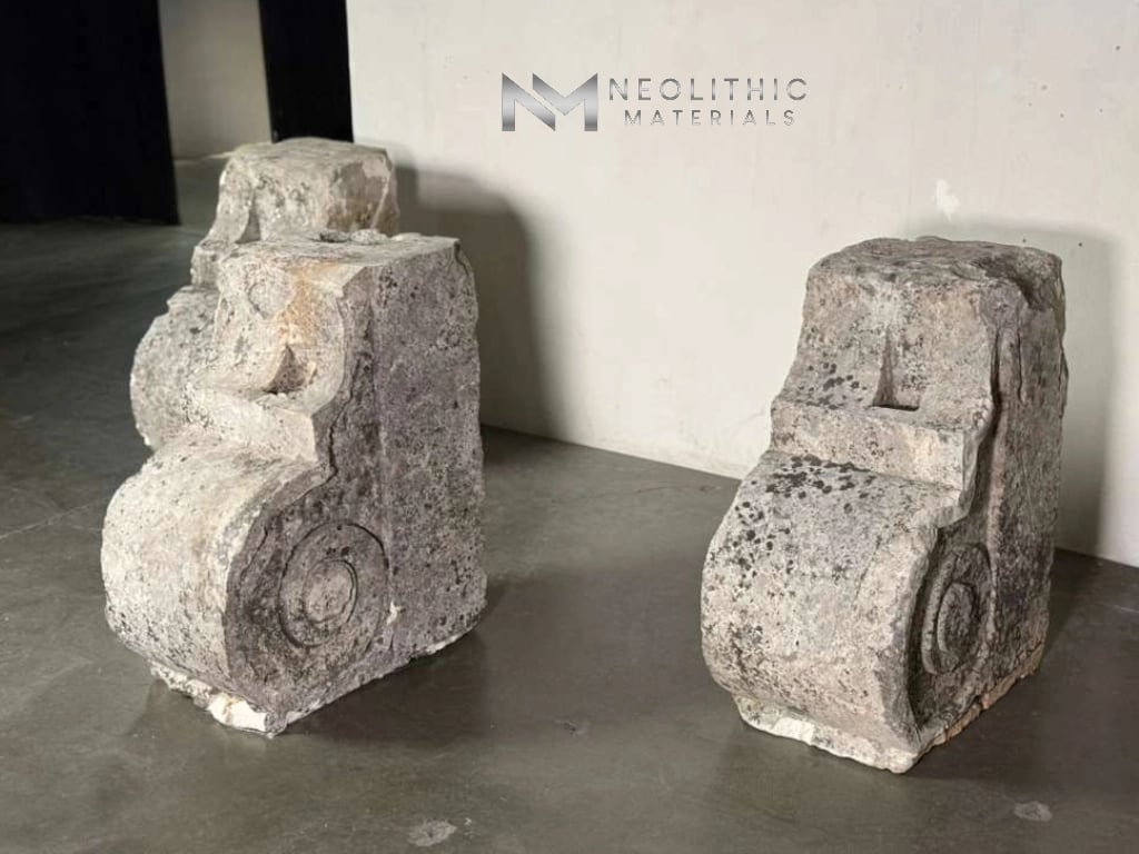 Miscellaneous FG103-46.L to 48.L14x22x30 indoor studio snapshot showcasing three antique architectural stone corbel blocks featuring ornate carved scroll details and a heavily weathered, pitted grey texture arranged on a dark concrete floor.